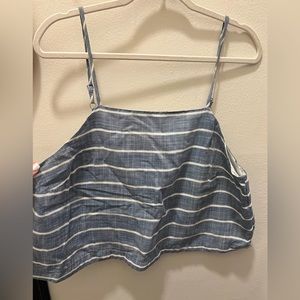 longer crop top with cross over detail in the back. Nautical blue & white